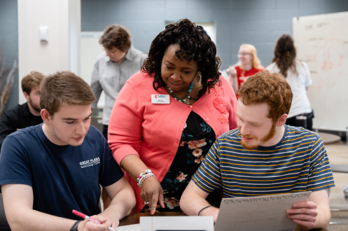 faculty helping two students