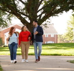 Students with administrator walking on campus