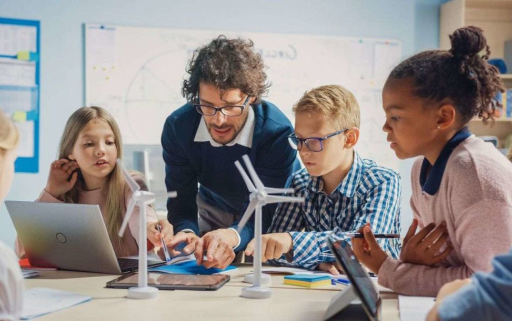 Teacher and a group of students around a table