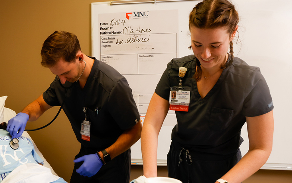 Two nursing students in a simulation lab