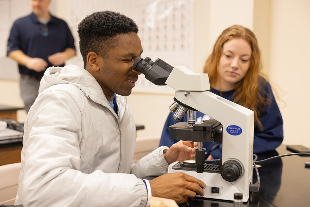 Student looking through a microscope