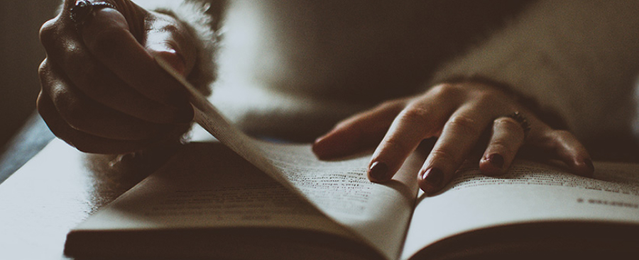 Person turning a page in a book