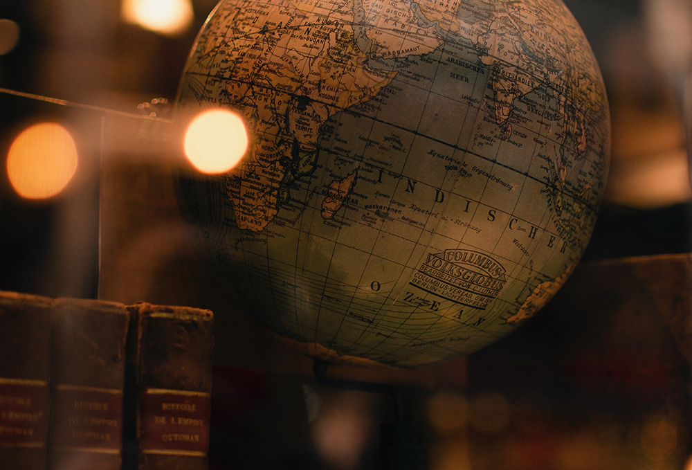 Globe on a shelf with books