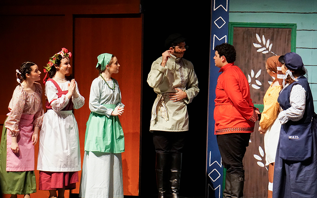 Students on stage performing a play