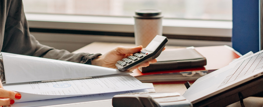 Person with a calculator at a desk