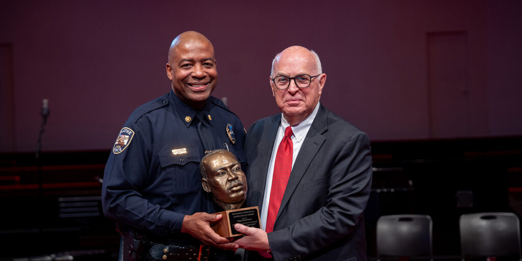 Captain John Roland accepts award from Dr. David Spittal