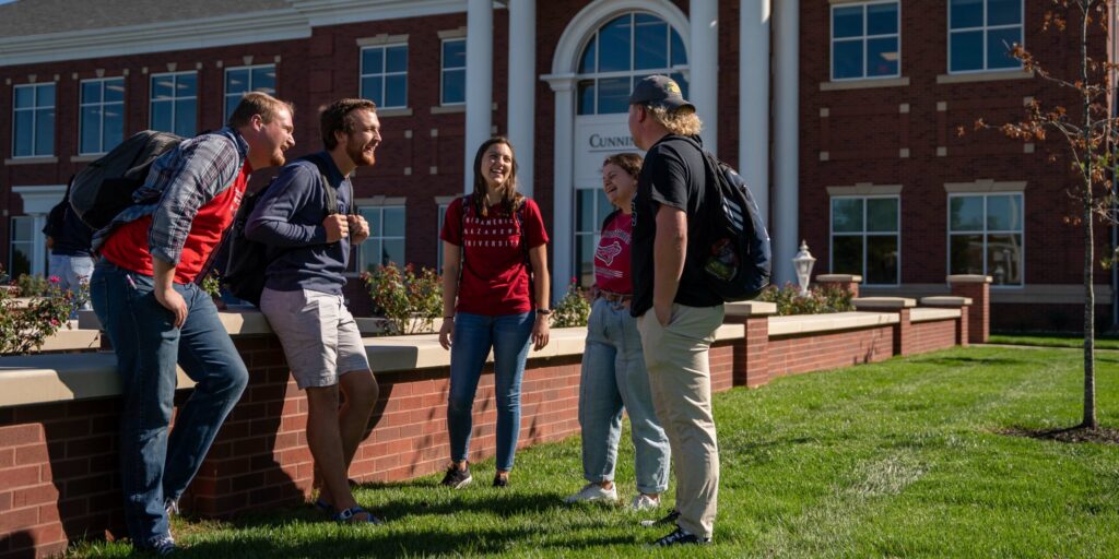 students in front of cunningham center on a sunny day