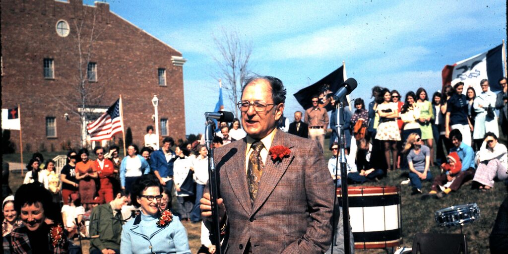 Dr Donald Metz in foreground at MNU initial accreditation celebration in 1974