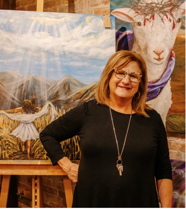 Artist Tammy Brown posing with her work