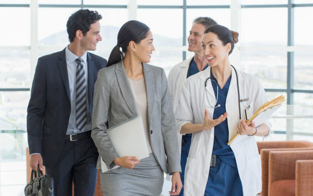 A group of business people and healthcare works walking together